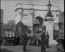 Milk Churns on a Lorry Being Driven Into a London Park as Police Officers Guard It, 1926. Creator: British Pathe Ltd.