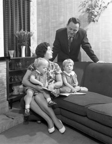 Family group looking at a brochure, Doncaster, South Yorkshire, 1963. Artist: Michael Walters
