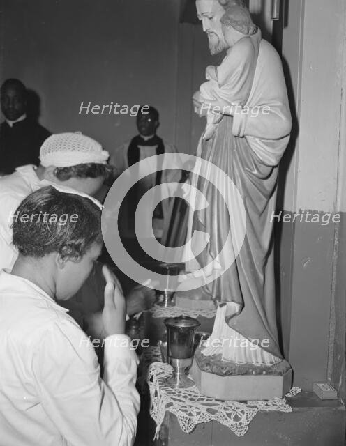 Worshippers before the altar in the St. Martin's Spiritual Church, Washington, D.C., 1942. Creator: Gordon Parks.