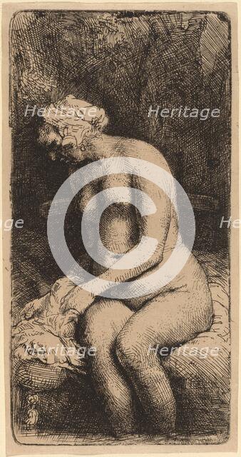 Nude Seated on a Bench with a Pillow (Woman Bathing Her Feet at a Brook), 1658. Creator: Rembrandt Harmensz van Rijn.