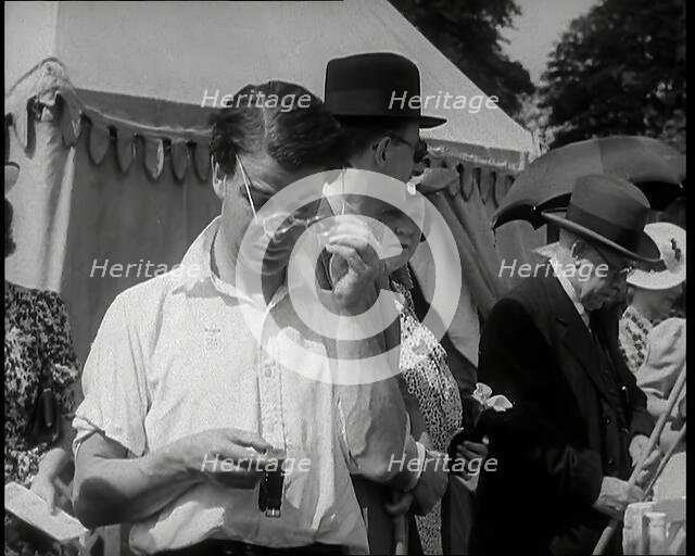 Emlyn Williams, Actor, Timing Punters by the 'Fishing for Fizz' Stall at  the Theatrical..., 1939. Creator: British Pathe Ltd.