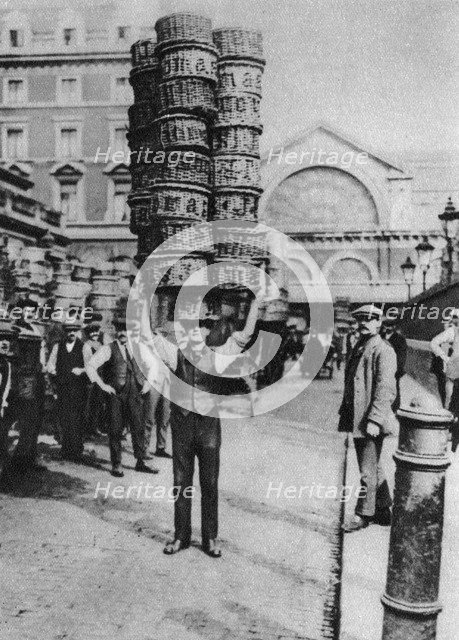 A man carrying many baskets on his head, Covent Garden, London, 1926-1927. Artist: Unknown