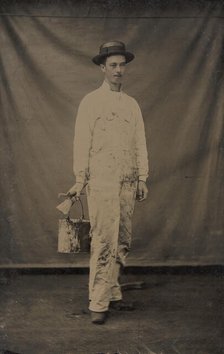 Painter in Paint-spattered Overalls with Brushes and Paint Can, 1870s-80s. Creator: Unknown.