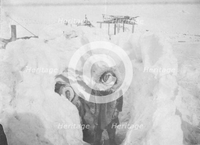 Alaskan Eskimos with their winter home half underground in village of Stebbins, c1900- c1930. Creator: Unknown.