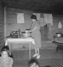 Wife of tobacco sharecropper in kitchen of home, Person County, North Carolina, 1939. Creator: Dorothea Lange.