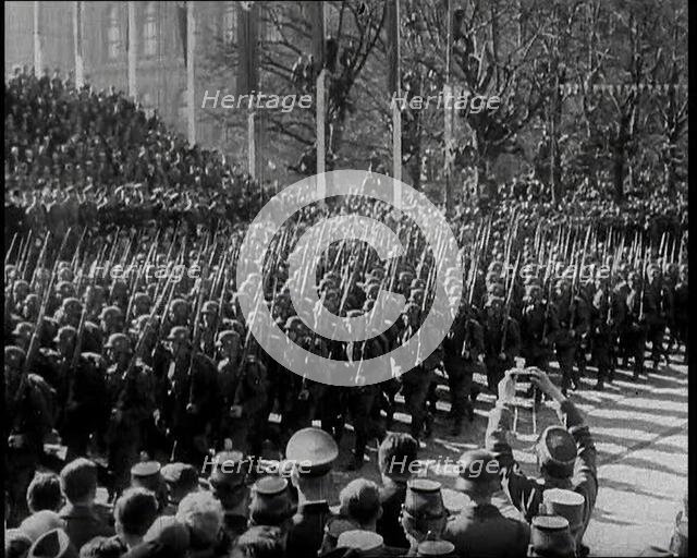 A Formation of Male German Soldiers Marching Past a Raked Platform of Officials on a Vienna..., 1938 Creator: British Pathe Ltd.