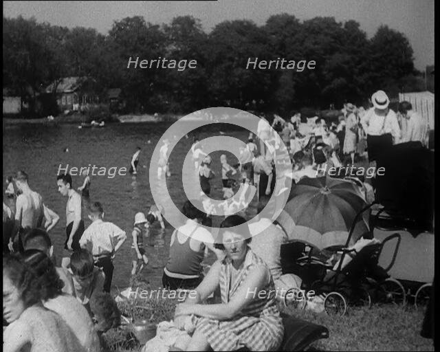 Large Group of People Sitting Outside and Paddling, 1933. Creator: British Pathe Ltd.