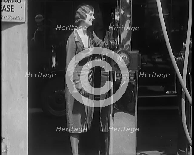 Female Civilians Working Petrol Pumps in a Garage, 1931. Creator: British Pathe Ltd.