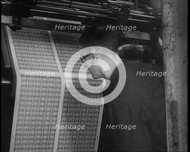 Man Inspecting Stamps Being Printed, 1936. Creator: British Pathe Ltd.