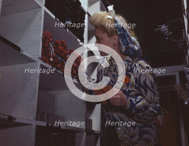 Clerk in one of the stock rooms of North American Aviation, Inc..., Inglewood, Calif. , 1942. Creator: Alfred T Palmer.