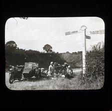 A group of people with two motorcycles and a sidecar having a picnic at the side of..., 1926-1939.  Creator: Norman Kingsley Harrison.