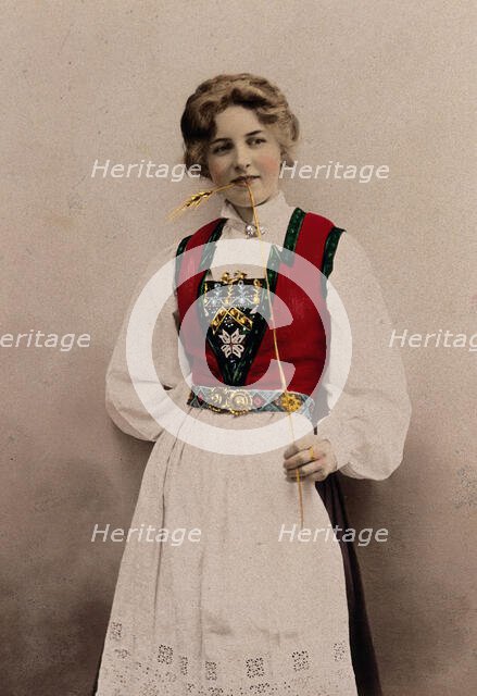 A young Norwegian woman, posing in a photographic studio wearing peasant dress, 1903. Creator: Solveig Lund.