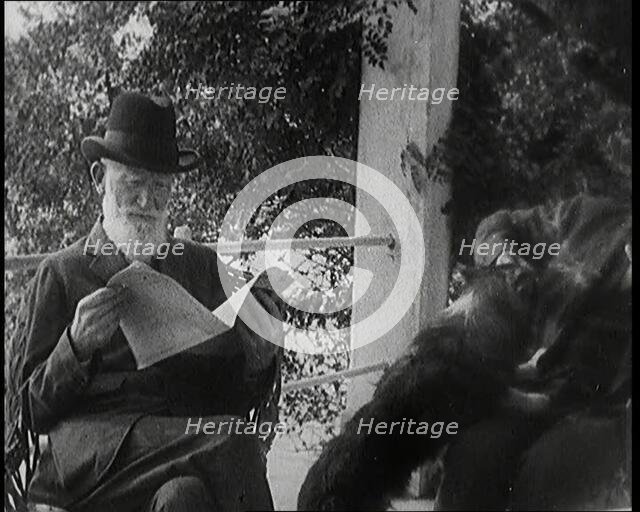 George Bernard Shaw and a Male Civilian Sitting in a Garden, 1920s. Creator: British Pathe Ltd.