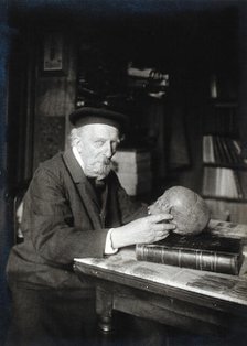 Adrien de Mortillet, holding a skull. Creator: Unknown.