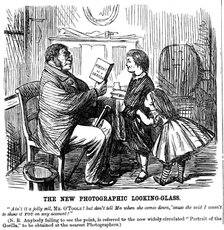 'The New Photographic Looking Glass', cartoon from Punch, everyday proof of man's origins, 1861. Artist: Unknown