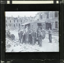 A group of men, possibly rescue workers, outside a tea van on a bomb damaged street, England, 1940-5 Creator: Norman Kingsley Harrison.