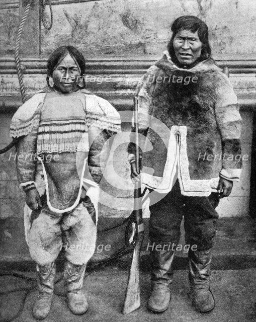 Eskimo hunter and his wife in winter costume, c1922. Artist: Brown Bros