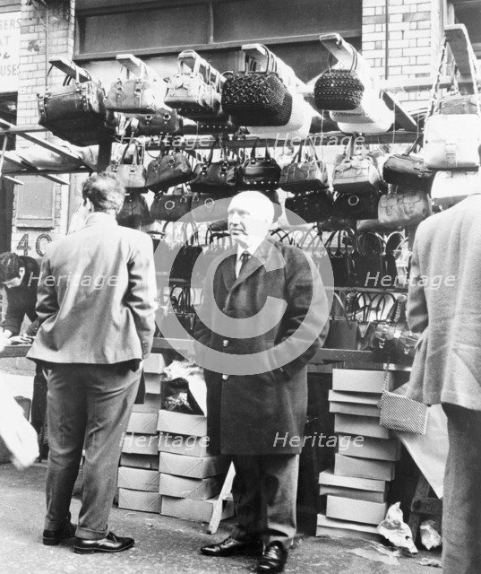 An East End market stall selling handbags, London. Artist: Unknown