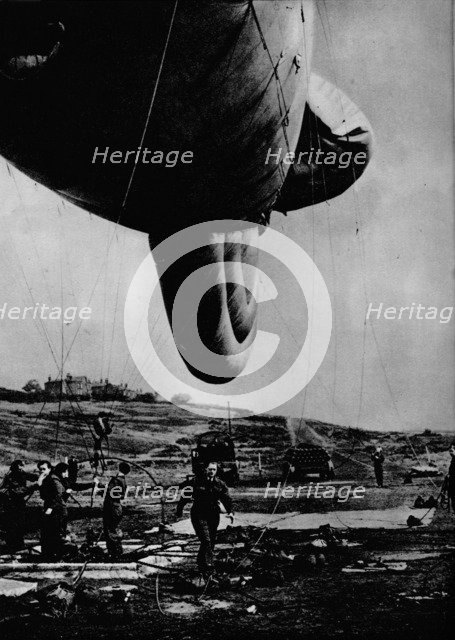Woman of the WAAF handling a barrage balloon, 1943. Artist: Unknown.
