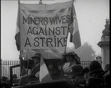 Women Gathering Around a Banner Reading 'Miners Wives Against a Strike', 1920. Creator: British Pathe Ltd.