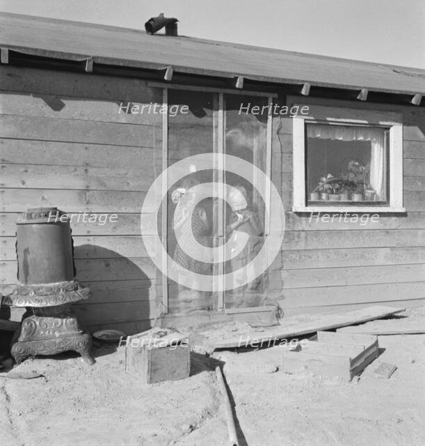 Two of the seven Browning children in doorway of their Oregon home, Dead Ox Flat, Oregon, 1939. Creator: Dorothea Lange.