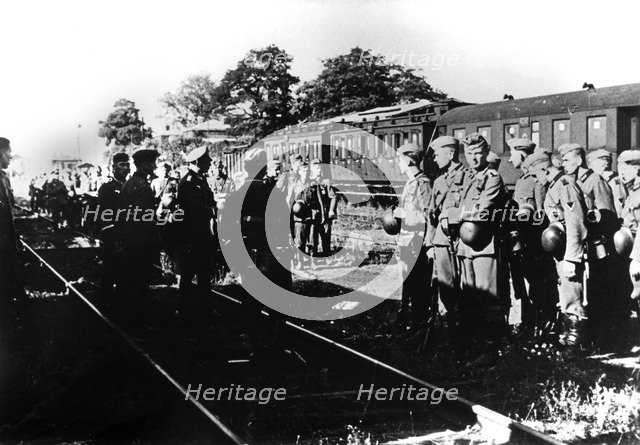German soldiers awaiting transportation in a railway station in the Paris suburbs, August 1940. Artist: Unknown