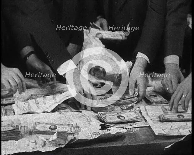 American Police Officers Counting Money Found in Relation To the Lindbergh's Kidnapping Case, 1930s. Creator: British Pathe Ltd.