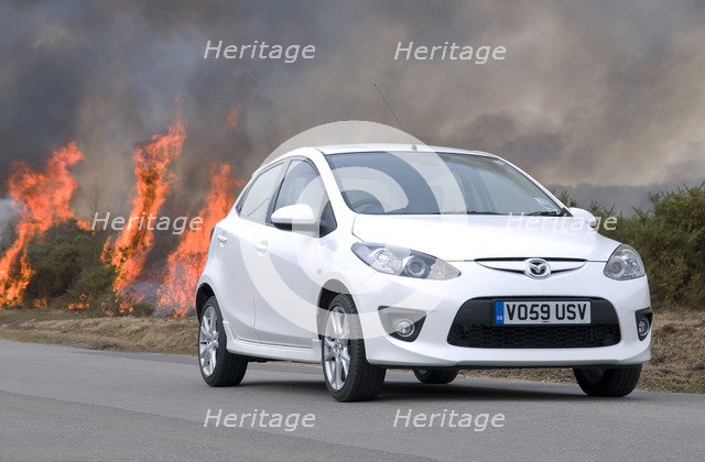 2010 Mazda 2 Sport, controlled burning in New Forest Artist: Unknown.