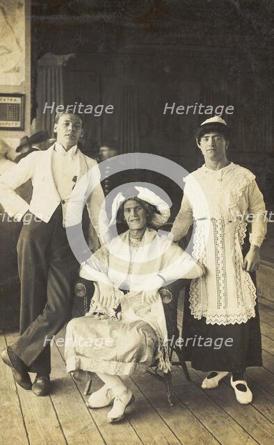 Three soldiers, two in drag, pose in costume, c1920. Creator: Unknown.