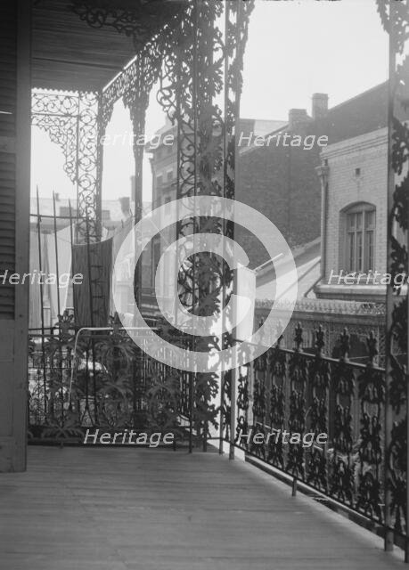 Upper level balconies with wrought iron on St. Peter Street, New Orleans, between 1920 and 1926. Creator: Arnold Genthe.