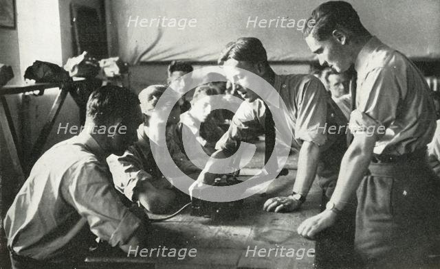 RAF personnel learning about weapons, 1941. Creator: Charles Brown.