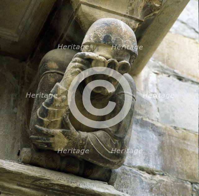 Façade of the Paeria of Cervera, anthropomorphic corbel of a personage wearing glasses, sick of t…