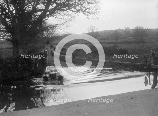 MG Magnette driving through a ford during a motoring trial, 1936. Artist: Bill Brunell.