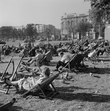 People relaxing on deck chairs amongst the pigeons in Hyde Park, London, 1960-1970. Creator: John Gay.