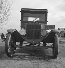 Model T Fords still carry migrants, FSA migratory labor camp at Farmersville, California , 1939. Creator: Dorothea Lange.