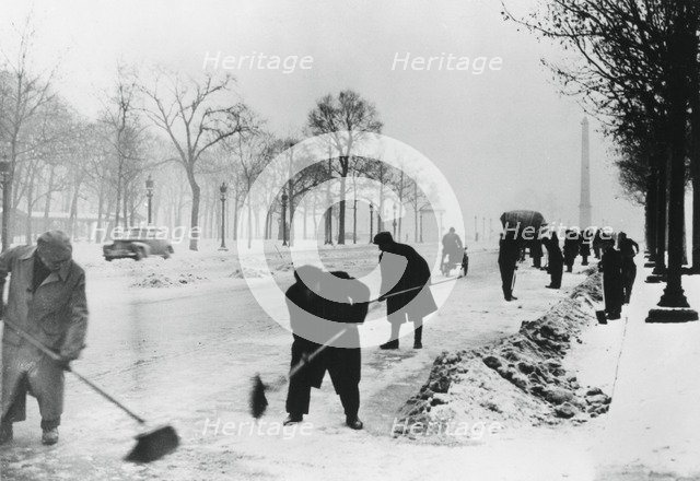 Clearing snow on the Champs Elysees, German-occupied Paris, winter, 1941. Artist: Unknown