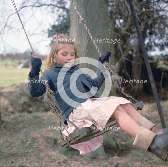Young gipsy girl on a swing, Charlwood, Newdigate area, Surrey, 1964.