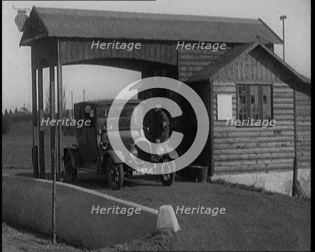 A Motorcar Driving Into the Forecourt of the First Petrol Station, 1920. Creator: British Pathe Ltd.