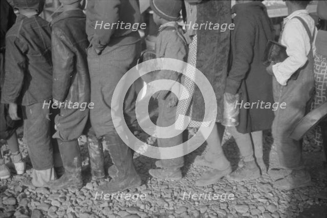 Possibly: Negroes at mealtime in the flood refugee camp, Forrest City, Arkansas, 1937. Creator: Walker Evans.