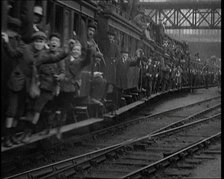 French People Hanging Onto the Outside of a Packed Train as It Drives Along, 1920. Creator: British Pathe Ltd.