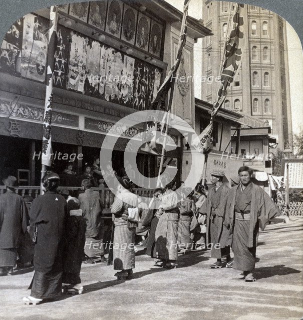 Watching a free show on Theatre Street, looking north to Asakusa Tower, Tokyo, Japan, 1904. Artist: Underwood & Underwood