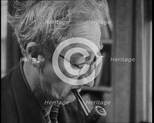 A.P. Herbert Smoking a Pipe, 1930s. Creator: British Pathe Ltd.