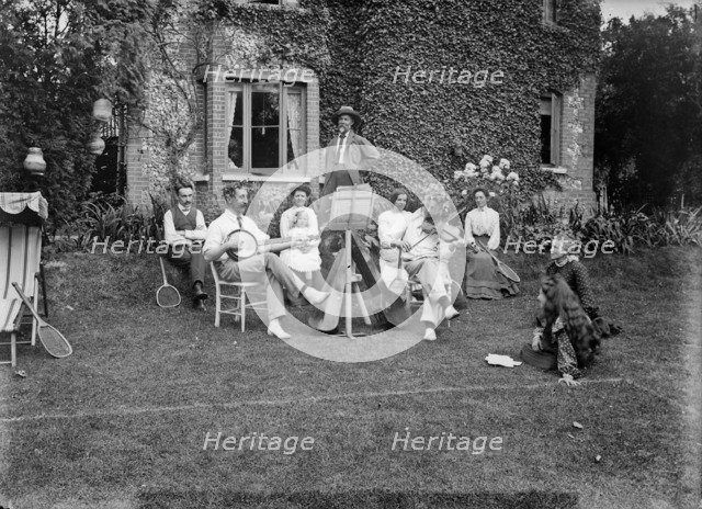 People playing music in a garden, c1896-c1920. Artist: Alfred Newton & Sons