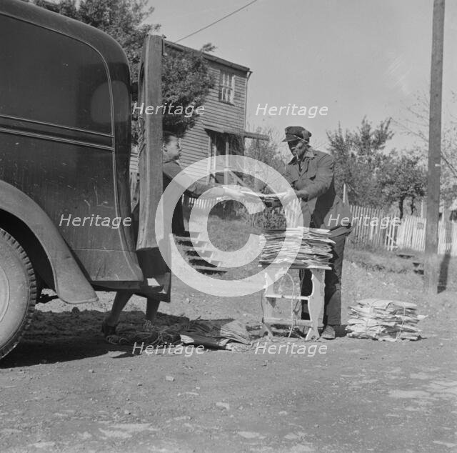 Mr. and Mrs. Venue Alsobrook wrapping papers for the government salvage..., Washington, D.C., 1942. Creator: Gordon Parks.