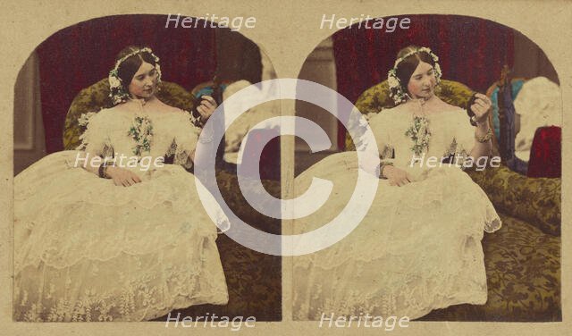 Woman seated in enlongated chair admiring herself in a hand mirror, about 1865. Creator: London Stereoscopic & Photographic Co.