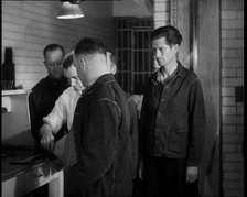 A group of Male Americans Civilians Wearing Prisoners Outfits Having Their Finger Prints..., 1930. Creator: British Pathe Ltd.