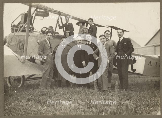 Group portrait in front of plane, 1915-1930. Creator: Fédèle Azari.