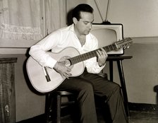 Ramon Calduch, Spanish singer playing guitar at home, 1967.