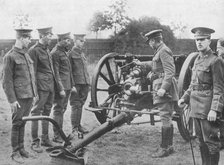 'Artillery recruits having the mechanism of an 18-pounder explained to them', 1915. Artist: Unknown.