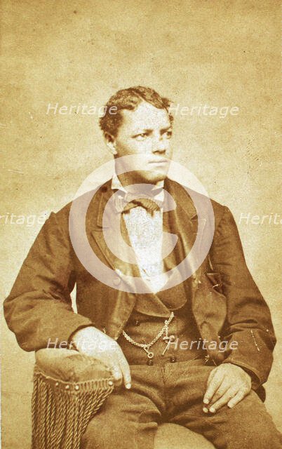 Studio portrait of unidentified seated young man, his left arm resting on chair, c1870-c1879. Creator: Unknown.